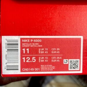 Nike P-6000  Size 11 active wear sneakers .  The color is metallic silver.